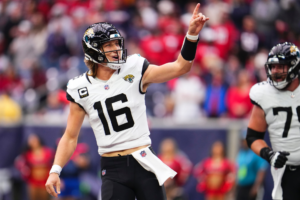 Trevor Lawrence pointing to the fans after a touchdown pass.